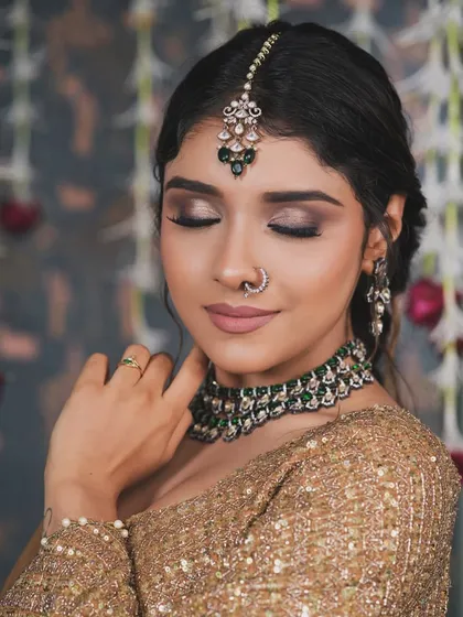 A close-up on the eye makeup. The blending is key to a soft yet defined smokey eye. It adds depth and drama without overwhelming the look, making it perfect for bridal portraits.