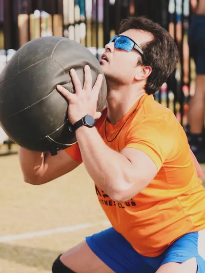 Performing a wall ball squat during The Yoddha Race. This exercise combines a full-body squat with an explosive throw, testing your power and coordination.