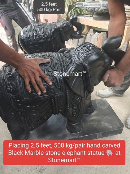 Our team positions a pair of hand-carved black marble elephant statues. These 500 kg pairs are perfect for creating a grand and auspicious entrance.