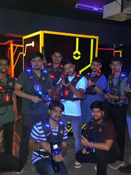 A large group of friends geared up for a massive laser tag battle.