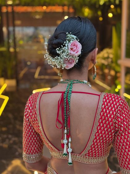 A close-up of the pink roses and baby's breath in this beautiful bridal bun.