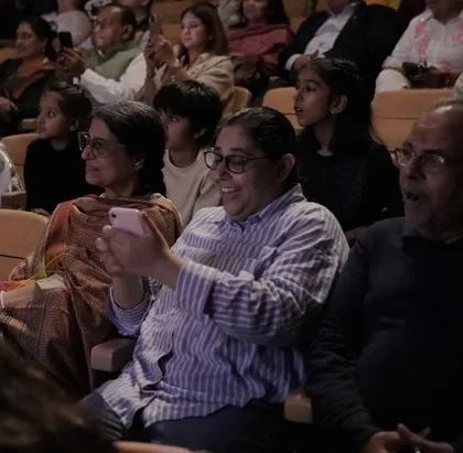 A proud parent captures the performance on her phone. We love seeing families share in the joy and pride of their child's achievements.