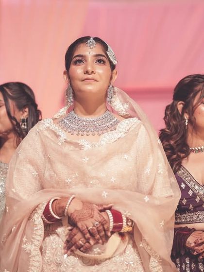 An emotional moment of the bride during her wedding ceremony, surrounded by her bridesmaids.
