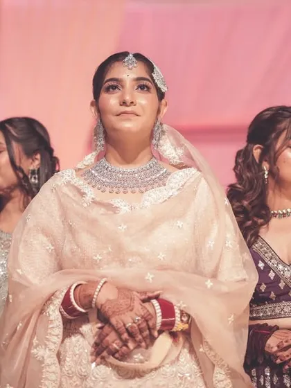 An emotional moment of the bride during her wedding ceremony, surrounded by her bridesmaids.