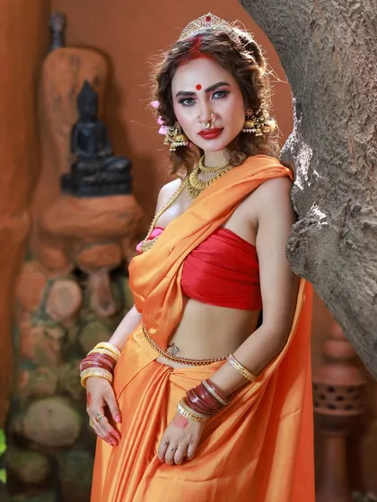 This was a powerful, goddess-themed shoot at a rustic Bangalore location. The model is styled in a vibrant orange saree, embodying a Durga-inspired look, complete with traditional makeup and accessories.