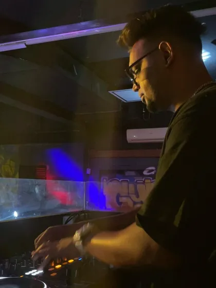 A side profile showing my concentration during a set. I take my craft seriously, which means no cringe tracks, just expertly mixed music.