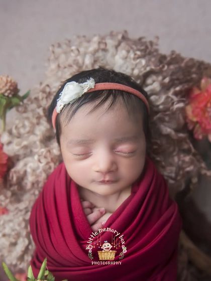The way the light falls on this baby's face is just beautiful. Proper lighting is key in newborn photography to create soft, gentle, and flattering portraits.