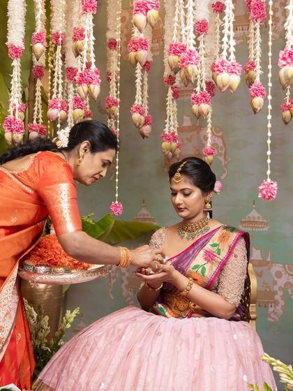 A tender moment between mother and daughter during a pre-wedding ceremony. The beautiful decor provides a worthy backdrop for these precious family interactions.