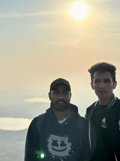 Two of our trekkers at Skandagiri, with the sunrise creating a beautiful backdrop.
