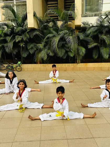 A group of students holding their splits. This shows the discipline and dedication that runs through our entire academy.