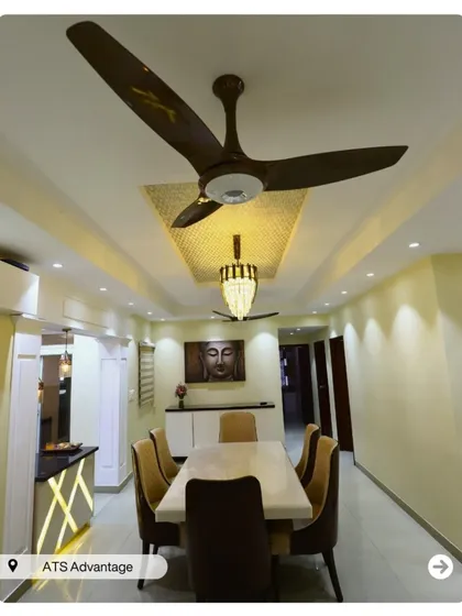 A dining area designed for serenity, featuring a Buddha painting and a beautiful ceiling design with a chandelier. The space feels calm and perfect for mindful meals.
