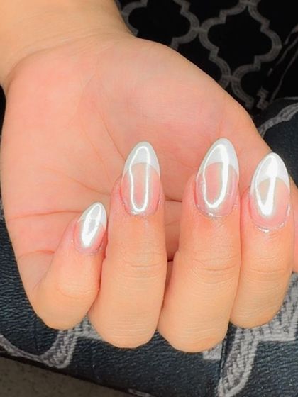 A single hand showing the beautiful holochrome effect over a classic French manicure.