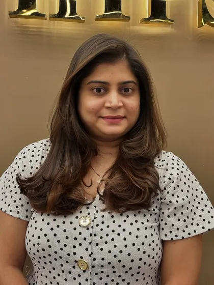 A happy client showing off her new hair color and layered cut. The soft, face-framing pieces and subtle highlights create a fresh and flattering style.
