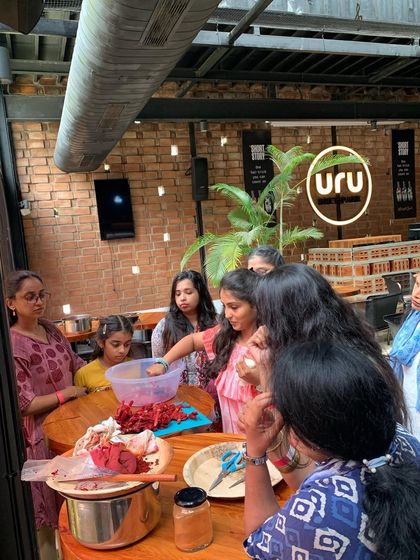 A group of participants gathered around the table, learning about the natural materials we use to create our dyes.