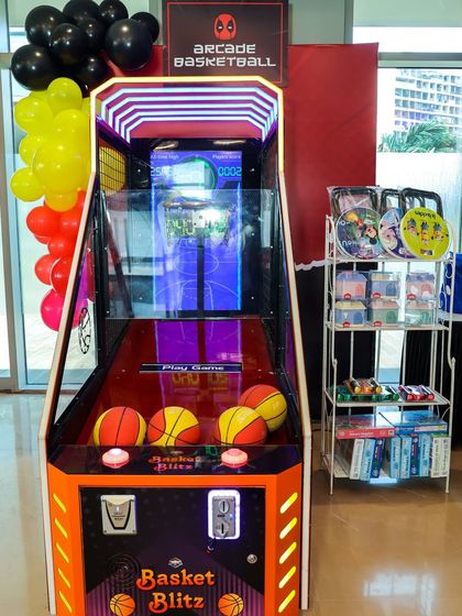 An arcade basketball game provides classic fun for guests at this Deadpool-themed event.