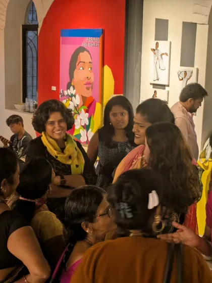 Laughter and conversation fill the room at a gallery event. It's a space where artists, activists, and community members meet as equals, breaking down barriers.