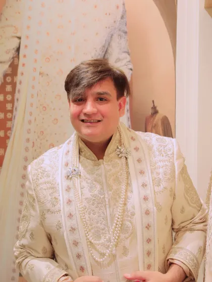 Accessorizing is key to completing any look. Here, I'm styling a Tasva sherwani with a pearl necklace and a brooch, adding a touch of royalty and glamour to the traditional ensemble. It's all about the finer details.
