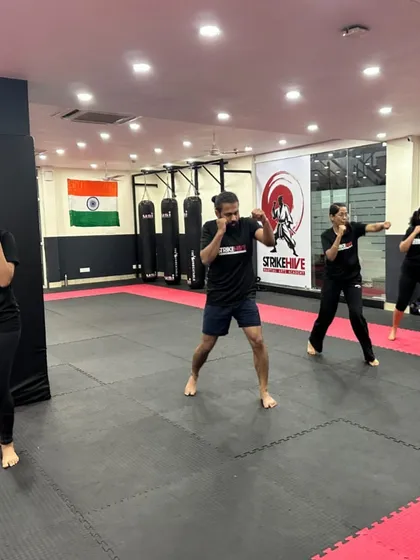 Students practice their boxing stance and punches during a kickboxing class. This foundational training is key to building confidence, awareness, and the resilience needed for effective self-protection.