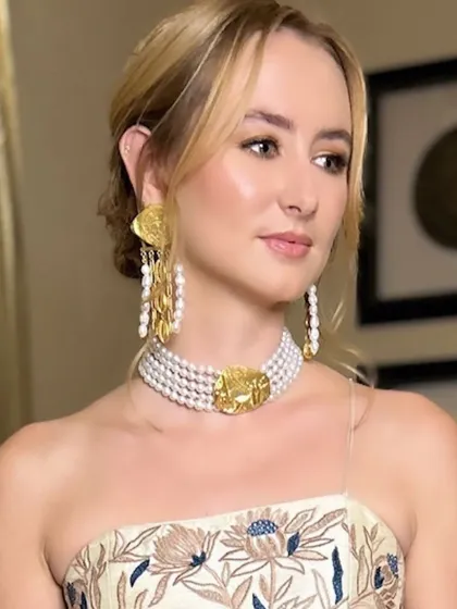 A sophisticated look for the sister of the bride. Her hair is styled in a soft, romantic updo, and her makeup is natural and glowing, highlighting her features beautifully.