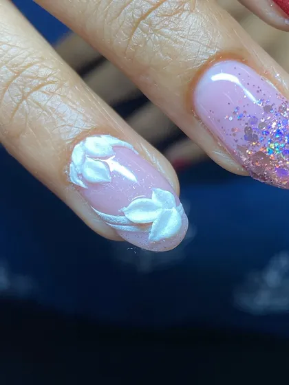 Detail of the hand-sculpted 3D white leaves on a sheer, glittery base.