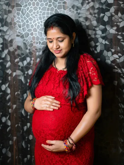 The beautiful glow of motherhood. This is a classic portrait from a studio maternity session, focusing on the pure love and anticipation for the new arrival.