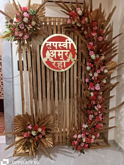 A rustic yet elegant backdrop for a home-based Tapasvi ceremony. I used a wooden slat screen, arches of pink roses and dried pampas grass, and a custom red sign.