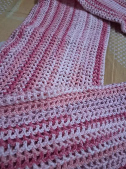 A close-up of the mesh stitch used in the pink bolero.