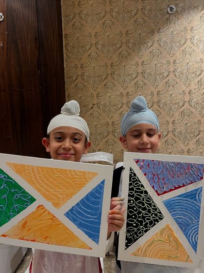 Two students from our texture painting workshop at the National Sports Club of India with their finished geometric art pieces.