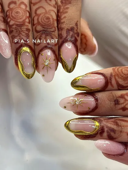 Your bridal look deserves nails that are just as special. Here, I've combined a soft, milky base with stunning 3D gold chrome frames and delicate starburst details, designed to perfectly complement traditional henna.