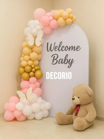 A simple and sweet "Welcome Baby" setup perfect for a home celebration. I used an arched backdrop with a custom message, a soft balloon garland in pink and yellow, and a large teddy bear to greet the new arrival.