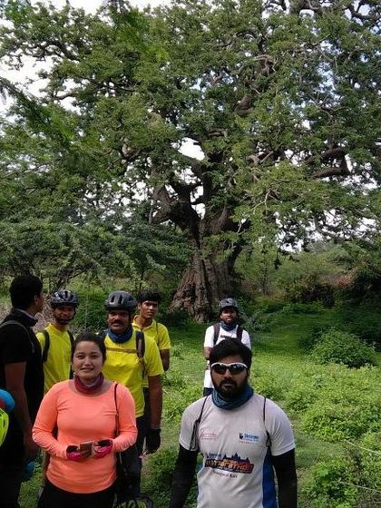 Exploring the ancient trees at Nallur Tamarind Grove. Our rides often take us to unique and historic locations.
