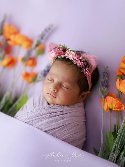 A duplicate image, this artistic portrait of a newborn among flowers remains a stunning example of my creative and colorful newborn sessions.