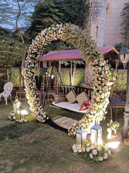 I love creating romantic settings like this for engagements or pre-wedding events. This beautiful swing, or 'jhula', is set inside a full circle arch of fresh white and peach roses, perfect for photos in a lovely garden.