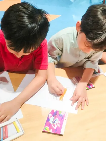 Two boys work together on a coloring project at our Independence Day craft table.