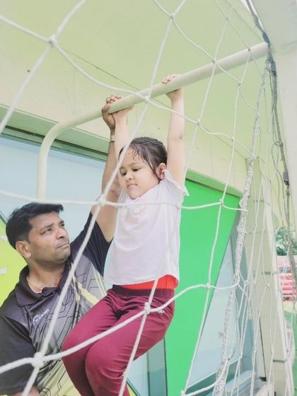 With a look of concentration, this camper tackles the climbing net. This activity is not just physically challenging but also builds problem-solving skills and resilience as children navigate their way to the top.