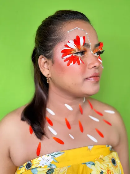 A side view of the creative floral makeup look, showing how the petals are placed to create a wing-like effect around the eyes.