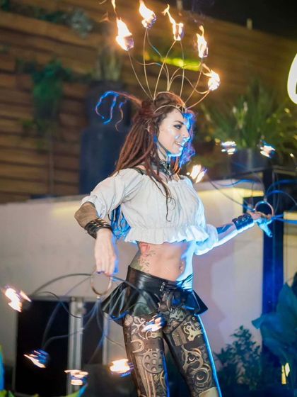 A solo performer showcasing a steampunk-style fire headdress and matching fans. The design combines elegance with an industrial edge, reflecting the core aesthetic of our steampunk chronicles.