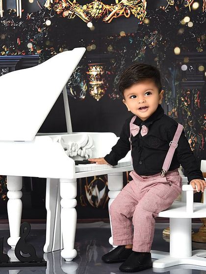 A classic portrait at the piano. The elegant backdrop and props create a timeless image that families will treasure for years.