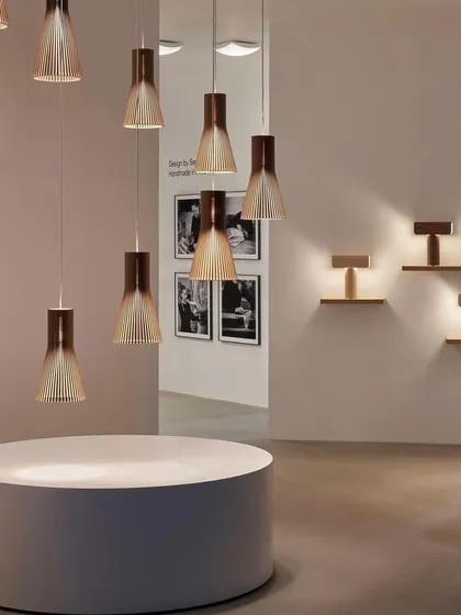 A gallery view of various Secto Design pendants and wall lights. This showcases the cohesiveness of the collection, allowing for a unified lighting scheme throughout a project.