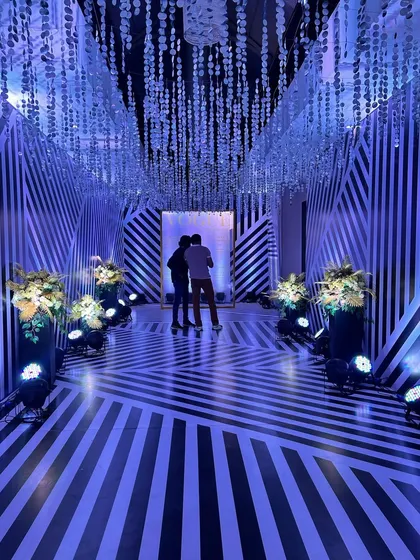 The black-and-white passage illuminated with cool blue light, showing how lighting can completely change the mood of the space.