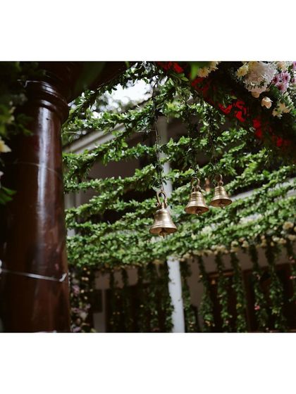 The gentle sound of brass bells added a subtle, traditional sensory element to this garden wedding.