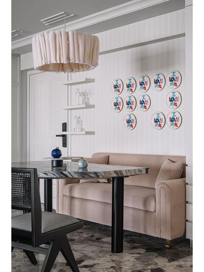 A close-up of the dining nook, showing the playful art and comfortable banquette seating.