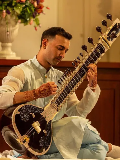 A close-up from my 25th birthday concert, playing a meditative raga. The henna on my hands is a key part of my performance ritual.