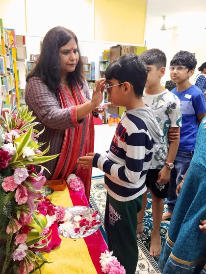 Applying a tilak as a blessing during the Ganpati pooja. We incorporate traditional elements into our sessions to give children a complete and authentic cultural experience.