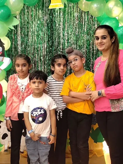 A group of children and a parent gather for a photo during our Janmashtami party, showcasing a fun day out for the whole family.