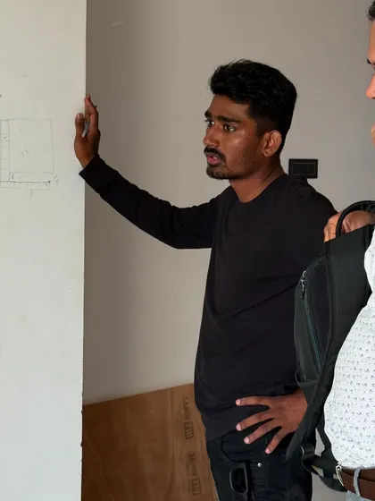 Explaining the plan to a team member on-site. Clear instructions are key to flawless execution.