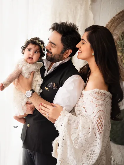 A classic family pose with a stylish twist, capturing the loving interaction between them.