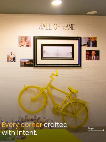 Every corner is crafted with intent. The 'Wall of Fame' and the bright yellow bicycle art piece are examples of how I use thematic decor to tell a story and make a space memorable and Instagram-worthy.