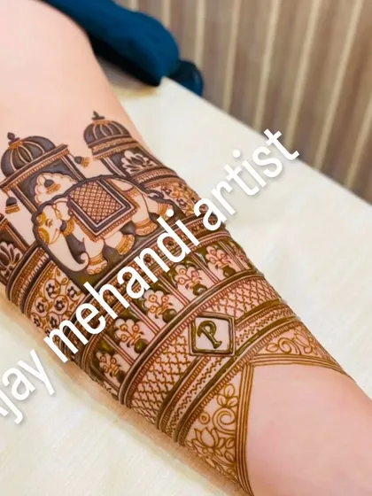 Another angle of the intricate arm mehndi, showing the fine details and shading on the elephant motif.