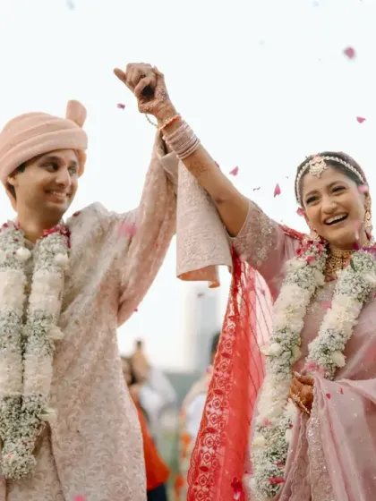 A candid shot of the couple's celebration, showered in petals. The soft, natural lighting and the elegant decor create a perfect frame for capturing these happy moments.